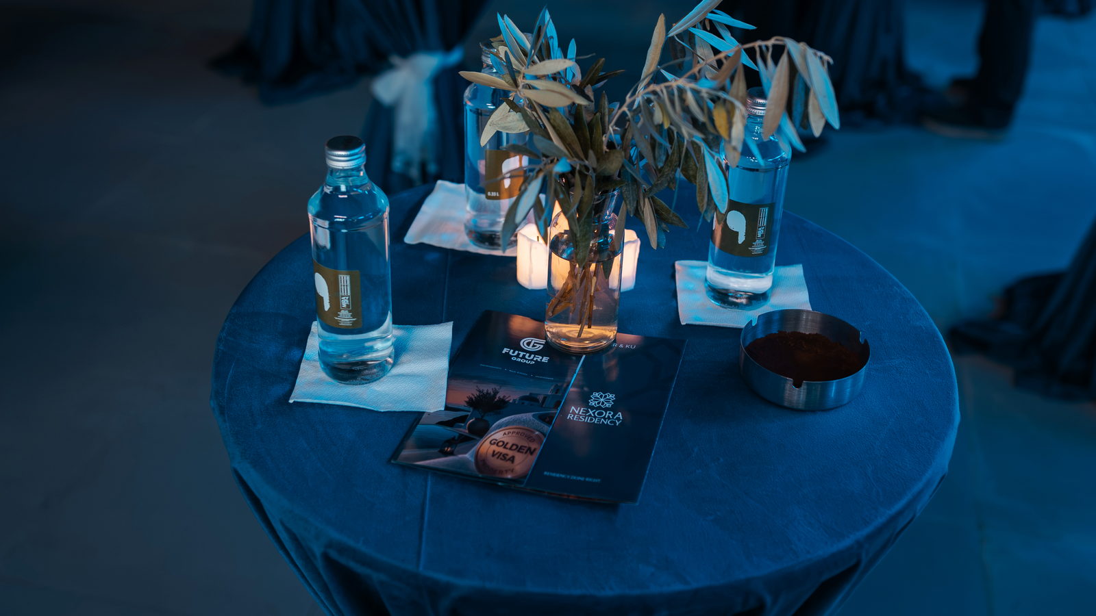 An olive branch, a candle and the Golden Visa portfolio, on every table